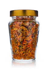 Dried marigold flowers in jar isolated on white background. Used as an anti-inflammatory tea in conventional and alternative medicine, including homeopathy.