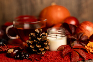 Cup of tea, candle, autumn fruits on the table. Autumn Evening Mood