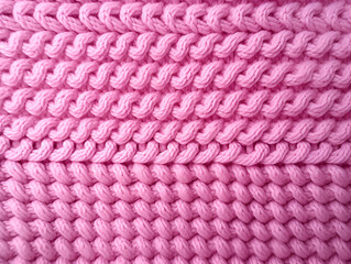 Fototapeta na wymiar Pink textured abstract knitted background 