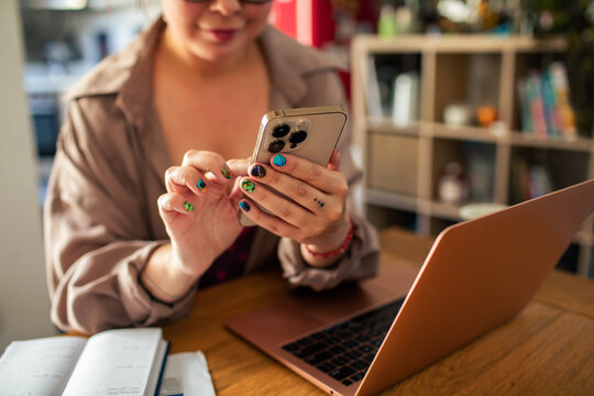 Focused young woman closely examines a message on her smartphone