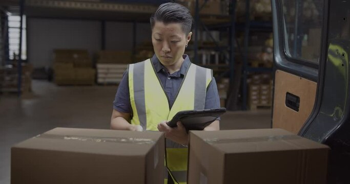 Warehouse Employee using Digital tablet and Barcode reader