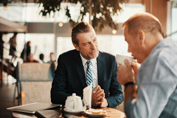 Business partners talking in a coffee shop