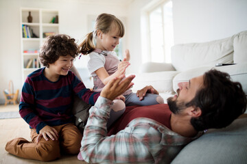 Father and children share a joyful moment together at home
