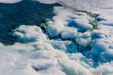 Bubbling hot springs water in a frozen stream