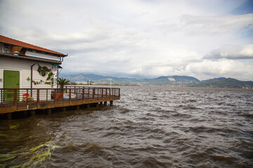 Scenery by the lake in Torre del Lago Puccini, Viareggio, Versilia, Tuscany, Italy. Wooden pier...