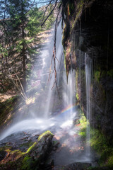Stunning waterfall Orlov kamen (Eagle's rock), on Old mountain, cascading down the cliff in the colorful forest and a rainbow at the bottom - 671245341