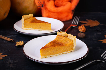 Pumpkin tart for autumn holidays. American pumpkin pie. Halloween background.