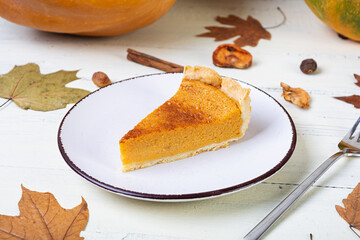 Pumpkin tart for autumn holidays. American pumpkin pie. Halloween background.
