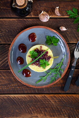 Mashed potato with beef, caramelized onion and cherry sauce