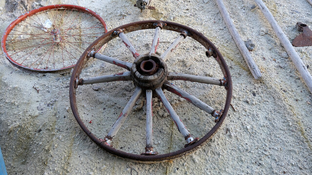 An old rusty antique wheel made of wood and metal