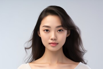 Fototapeta premium Young charming woman on a light background. Natural makeup. Natural beauty.