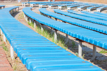 Wooden colored bench of spectators in the open air of a performance theater, close-up. AI generated.