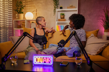 Couple of multiracial women recording episode of internet podcast