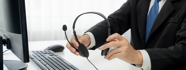 Business people wearing headset working in office to support remote customer or colleague. Call center, telemarketing, customer support agent provide service on telephone video conference oratory call - obrazy, fototapety, plakaty