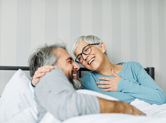 couple senior bed woman man home wife husband love together elderly caucasian adult happy retirement mature male old bedroom smiling resting retired aged relaxation leisure lying relationship