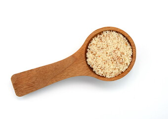 Fototapeta na wymiar Shelled and ground Ground, milled, crushed almond nuts in a wooden spoon isolated on white. Edible, dried, brown seeds of Prunus dulcis. Ingredient in marzipan, nougat, cookies.