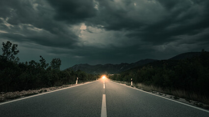 Asphalt road panorama in countryside on cloudy day. Road in forest under dramatic cloudy sky. Image...