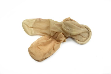 Women's used nylon tights pantyhose beige color on isolated white background.