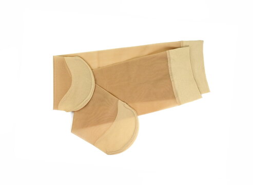 Women's nylon tights body color isolated on white background. Women's nylon stockings beige color. 