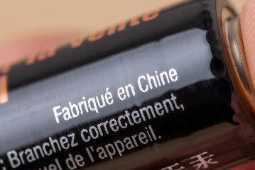 Made in China written in French on battery. Producing batteries in China and exporting them to France