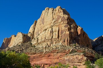 Fototapeta na wymiar A drive through the northern edge of Capitol Reef National Park brings you along a winding surrounded by steep, beautiful red rock walls