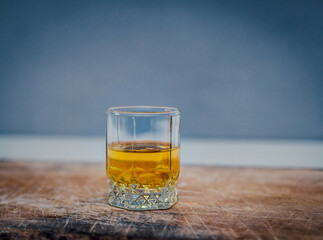 glass of brandy on wooden table