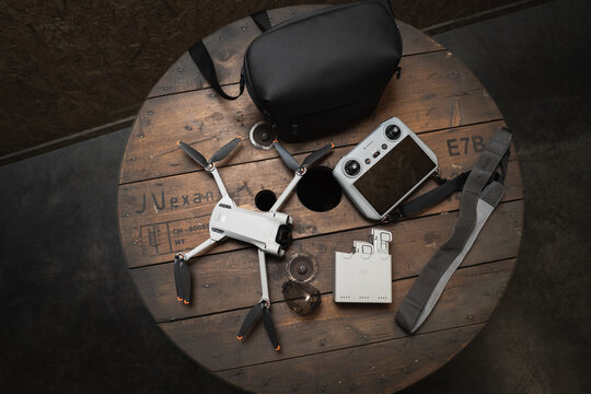 Estonia, Tallinn August 23, 2023.  Compact folding drone Dji mini 3 pro with rc control panel and additional batteries.