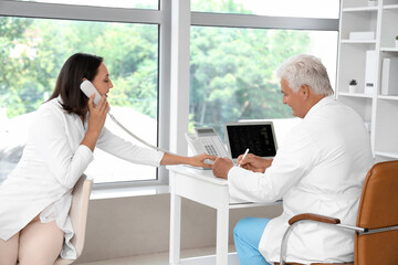Fototapeta premium Doctors working at their workplaces in medical office