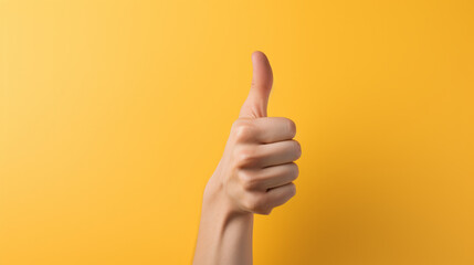A person giving a thumbs up sign on a yellow background - 671274154