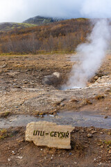 dormant little geysir at iceland with steam vertical