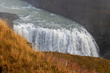Gulfoss waterfall in iceland with grass at the foreground