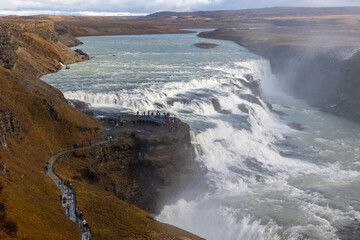 Gulfoss waterfall in iceland with people walking next to it