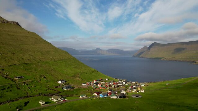 FAROE ISLANDS - JULY.16.2023 - Excellent aerial footage of a village on the coast of Funningur in the Faroe Islands.
