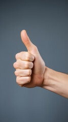 A hand giving a thumbs up sign