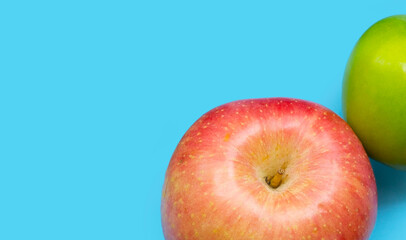 Fresh apples on blue background.