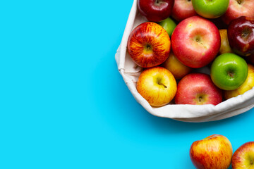 Fototapeta na wymiar Variety of fresh apples on blue background.