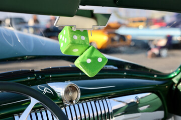 green fuzzy dice inside the vintage car