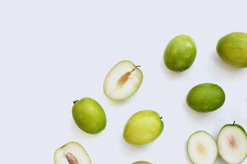Green jujube fruits on white background.