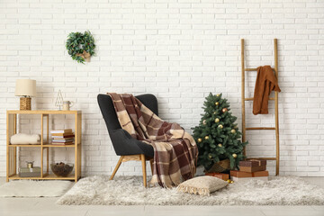 Interior of living room with armchair and Christmas tree