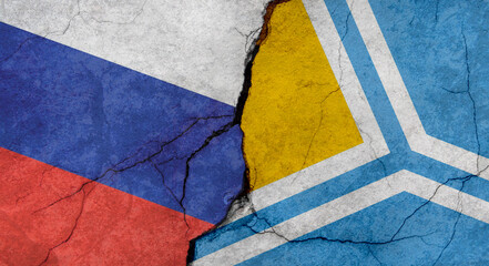 Flags of Russia and Tuva, texture of concrete wall with cracks, grunge background, military conflict concept