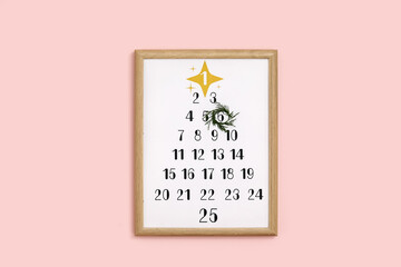 Christmas calendar on pink wall