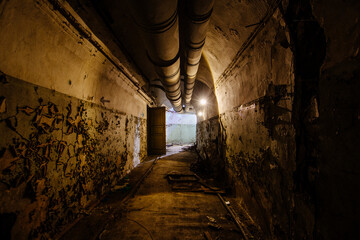 Old vaulted corridor of Soviet bunker, echo of Cold War
