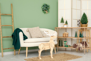 Interior of living room decorated for Christmas with sofa and shelf unit