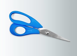 A pair of blue school scissors on a desk
