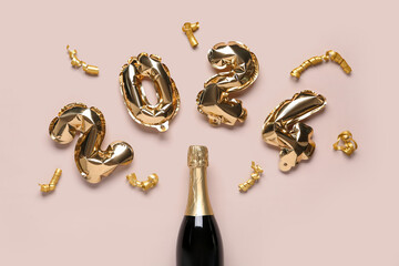 Figure 2024 made of balloons, ribbons and champagne bottle on beige background