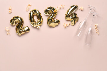 Figure 2024 made of balloons, ribbons and glasses for Christmas celebration on beige background