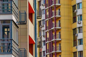facade of a modern apartment building with balconies and colorful windows
