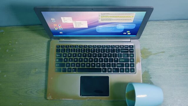 Overhead View Of Coffee Spilled On Laptop