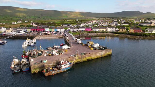 IRELAND- 8.27.2023 -Excellent aerial footage circling clockwise around a harbor with many boats docked off the coast of Portmagee, Ireland.
