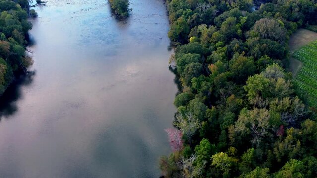 Slow moving Catawba River and island at sunset in early fall